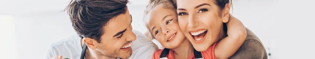 Smiling family portrait with parents and child