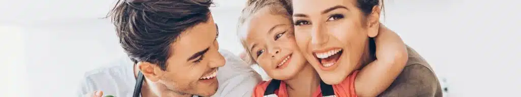 Smiling family portrait with parents and child