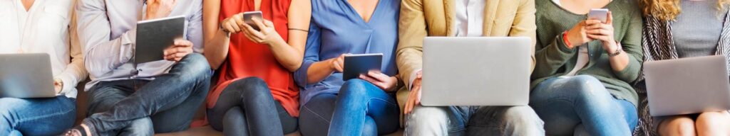 Group of people using laptops, tablets, phones