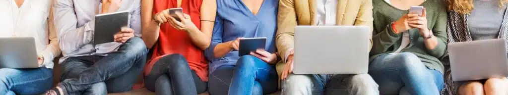Group of people using laptops, tablets, phones