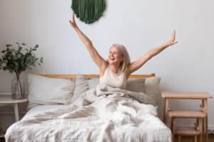 Woman in her 50s waking up with high energy and a great mood after starting treatment with BHRT pellets