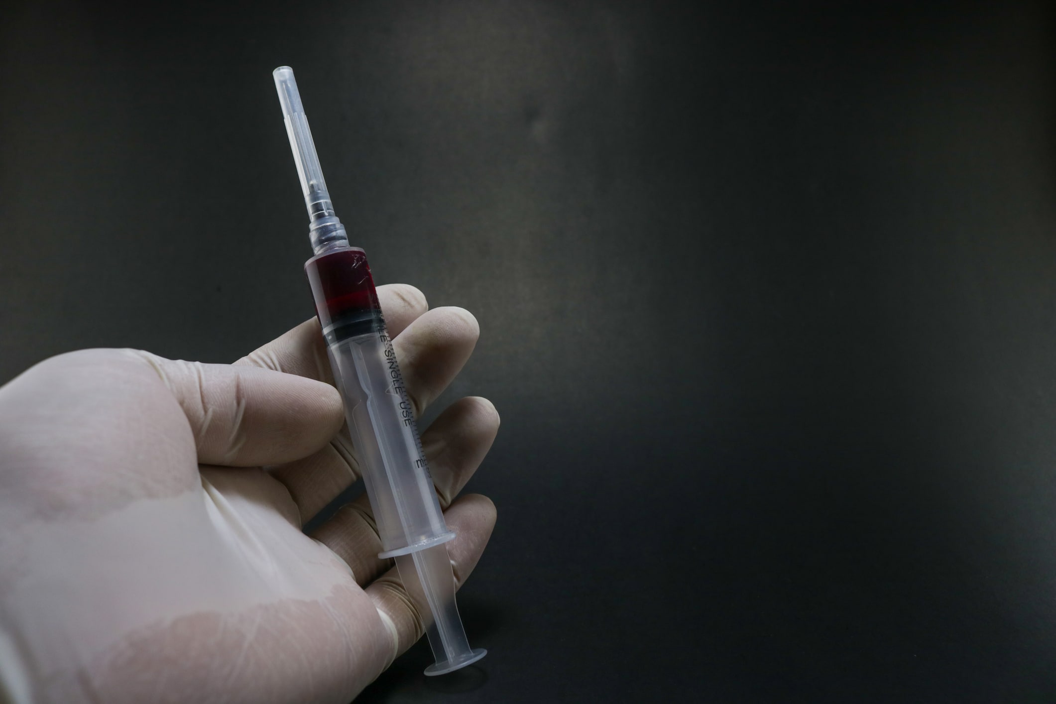 Injection filled with medicine holding in hand