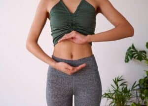 Person framing stomach with hands