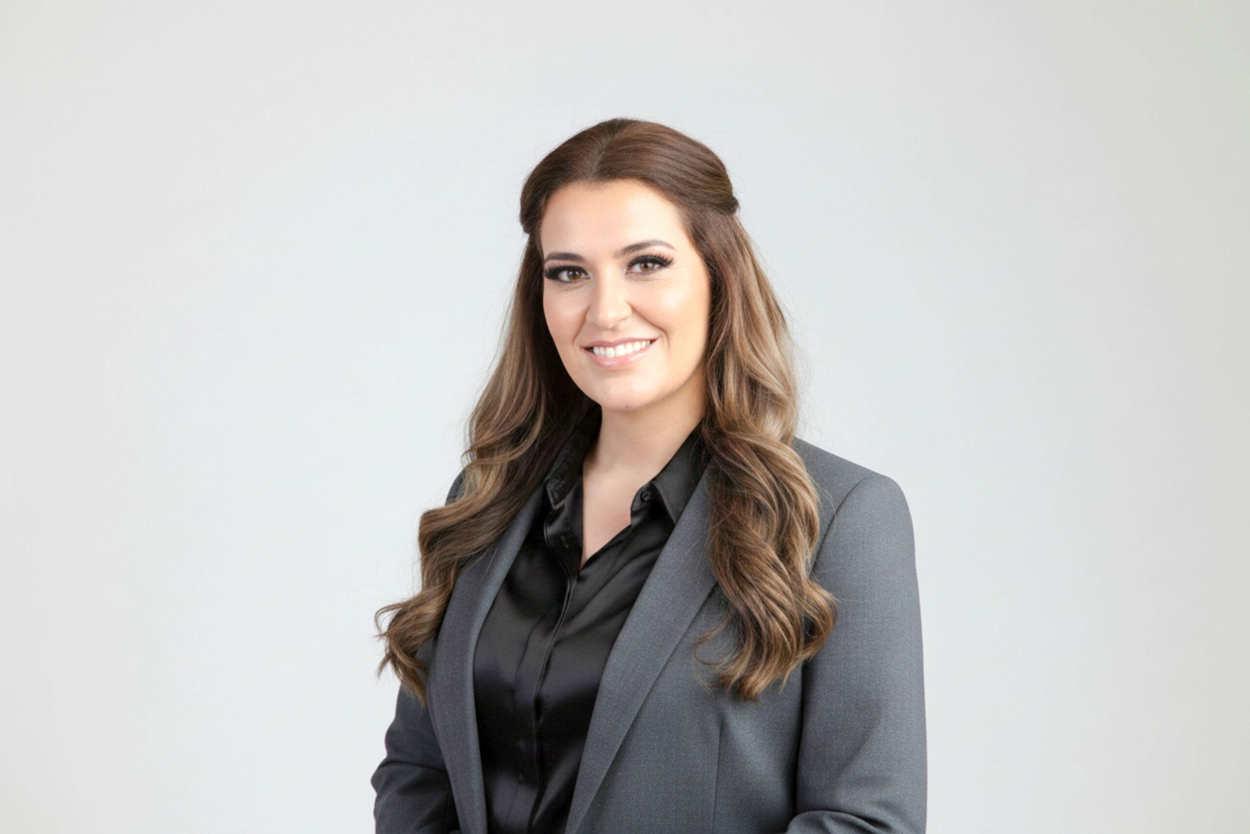 Smiling professional woman in gray blazer